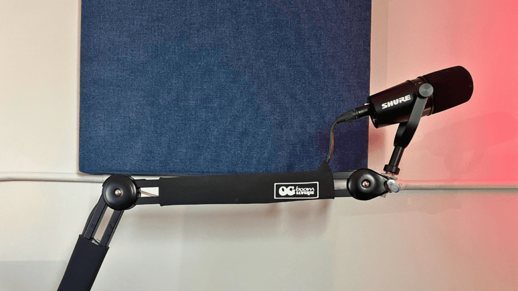 to show a microphone boom arm, which is a common form of mic stand that a podcaster would use